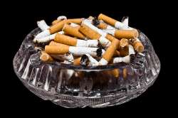 full-crystal-ashtray-of-cigarette-butts-on-black-background203337-2352.jpg