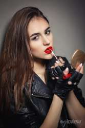 woman-opens-her-tender-lips-and-while-paints-it-with-lipstick-attractive-and-beautiful-girl-paint-lips-a-red-lipstick-and-looking-at-the-camera-portrait-of-make-up-girl-isolated-on-dark-background-700-119388787.jpg