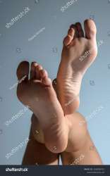 stock-photo-beautiful-woman-s-bare-feet-with-shadows-and-lighting-on-gray-studio-background-2436296721.jpg
