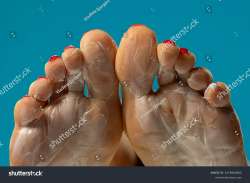 stock-photo-female-soles-with-foot-mask-on-blue-studio-background-2476940405.jpg