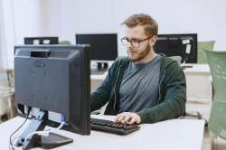 man-with-glasses-student-computer-science-class-person-uses-computer-1.jpg